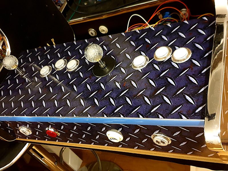 Control panel being wired: joystick and illuminated buttons on the chequer-plate deck