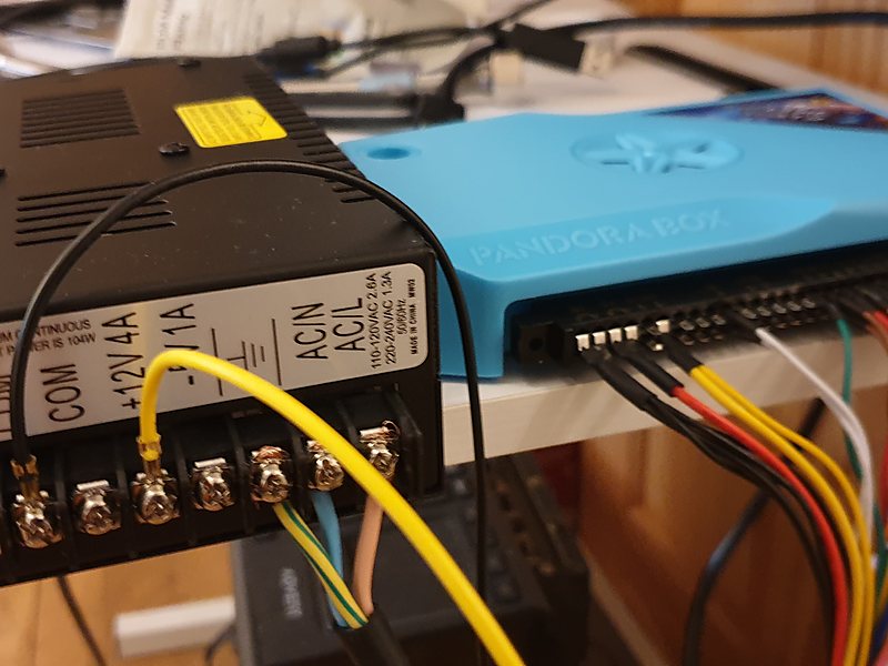 Power supply and game board being wired on the bench