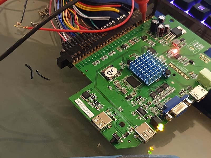 Testing a game board with a multimeter before it goes into a cabinet