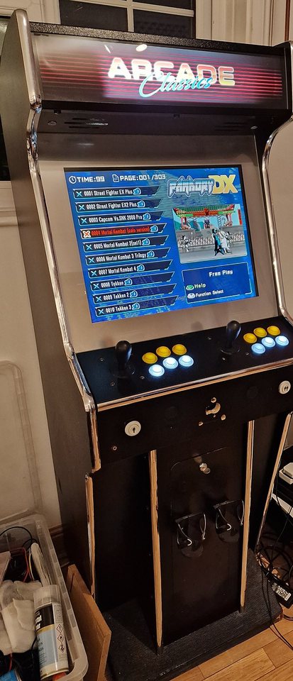 Full-height stand-up arcade cabinet, two-player control deck, game menu on screen